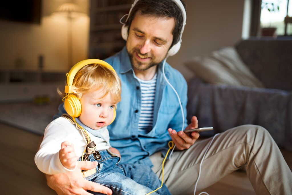 a dad and child with headphones